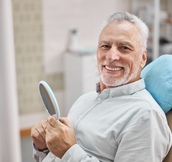 Smiling senior man sitting in dental chair in Wesley Chapel dental office